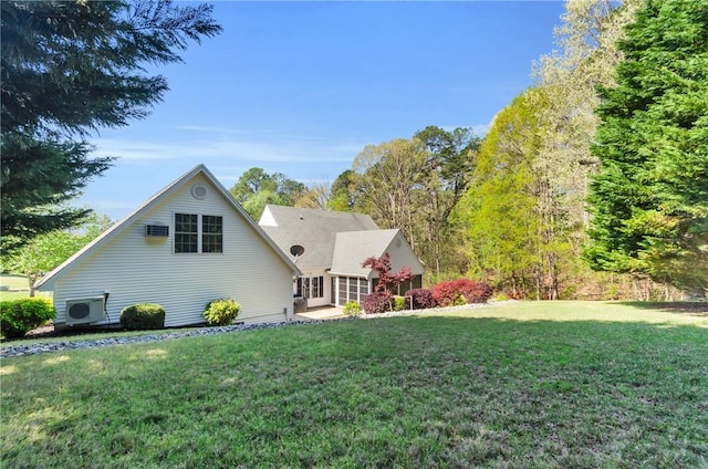 back of property featuring a yard and ac unit