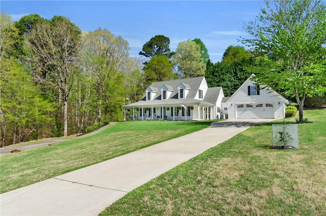 view of front of property featuring a porch, a garage, a front yard, and concrete driveway