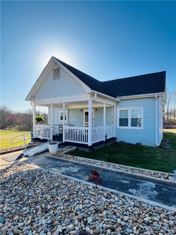 810 John St, Pickens, SC 29671 - view of front facade with a front yard, a shingled roof, and covered porch