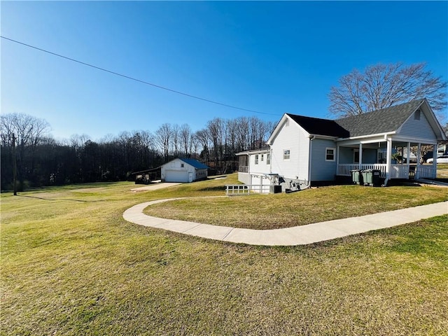 810 John St, Pickens, SC 29671 - view of side of home featuring an outdoor structure, covered porch, a yard, and a garage