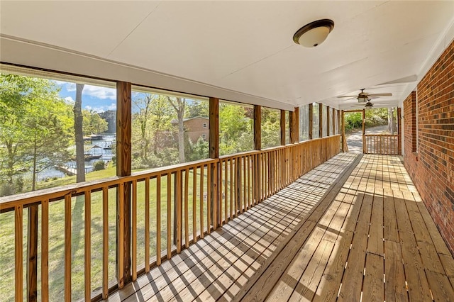 unfurnished sunroom with a ceiling fan