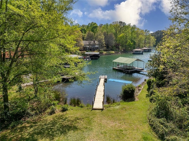 view of dock featuring a water view and a yard