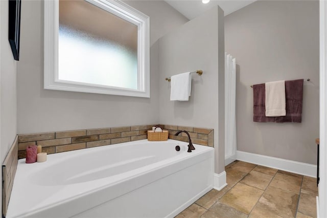 101 Cabernet Way, Travelers Rest, SC 29690 - full bathroom featuring a garden tub, a shower with shower curtain, stone finish floor, and baseboards