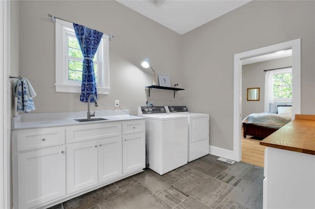 101 Cabernet Way, Travelers Rest, SC 29690 - laundry room featuring washer and clothes dryer, cabinet space, baseboards, and a sink