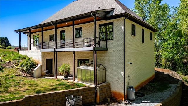 101 Cabernet Way, Travelers Rest, SC 29690 - rear view of property with brick siding, a shingled roof, and a balcony