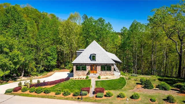 101 Cabernet Way, Travelers Rest, SC 29690 - view of front facade featuring concrete driveway, a front yard, a forest view, and stone siding