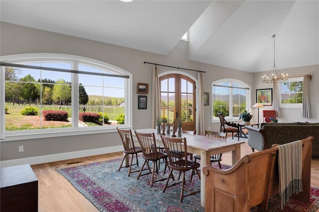 101 Cabernet Way, Travelers Rest, SC 29690 - dining room featuring an inviting chandelier, light wood-type flooring, high vaulted ceiling, and baseboards
