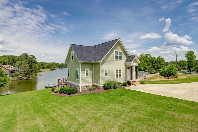 217 Jackson Rd, Iva, SC 29655 - view of side of home featuring a lawn, concrete driveway, roof with shingles, and a water view