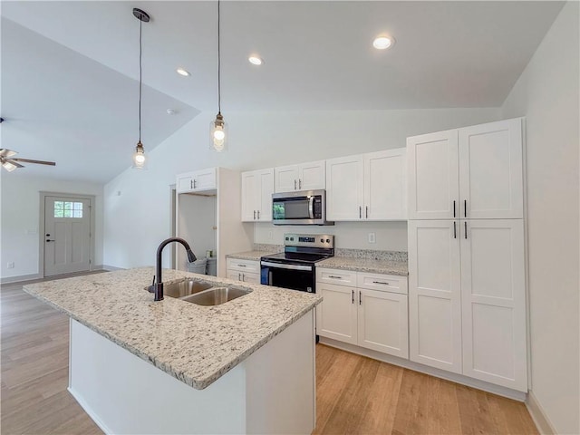 kitchen featuring stainless steel appliances, a sink, white cabinetry, light wood-type flooring, and recessed lighting