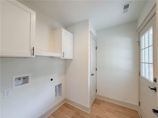 washroom featuring washer hookup, hookup for an electric dryer, light wood-style floors, cabinet space, and baseboards