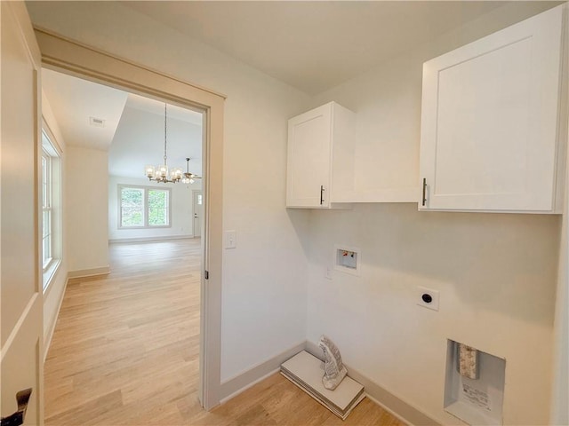 laundry area featuring electric dryer hookup, hookup for a washing machine, light wood-type flooring, a chandelier, and baseboards