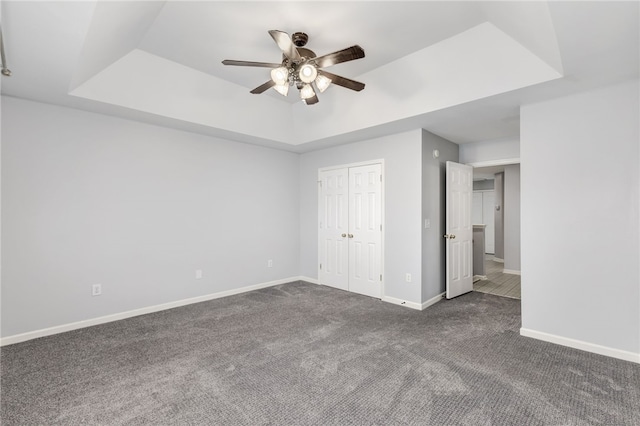 101 Pin Oak Ct, Easley, SC 29642 - unfurnished bedroom featuring a closet, baseboards, a raised ceiling, and dark colored carpet