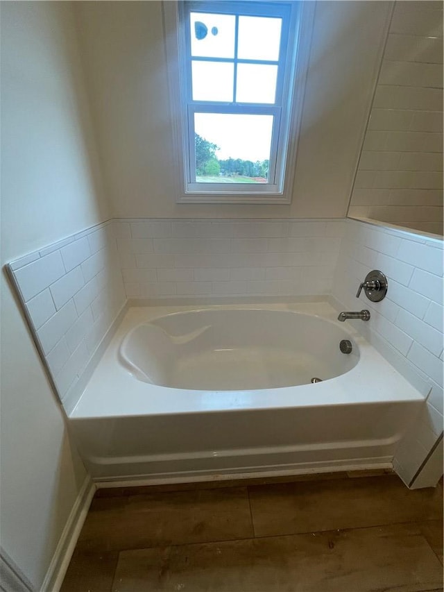 full bathroom featuring wood finished floors and a garden tub