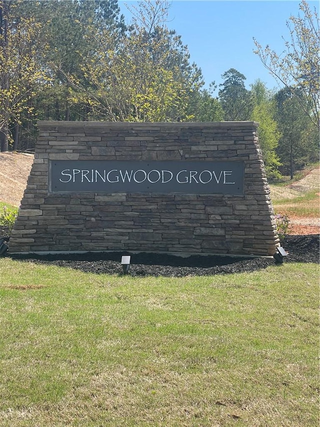 community / neighborhood sign with a yard