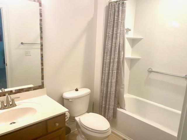 full bath featuring shower / tub combo, vanity, and toilet