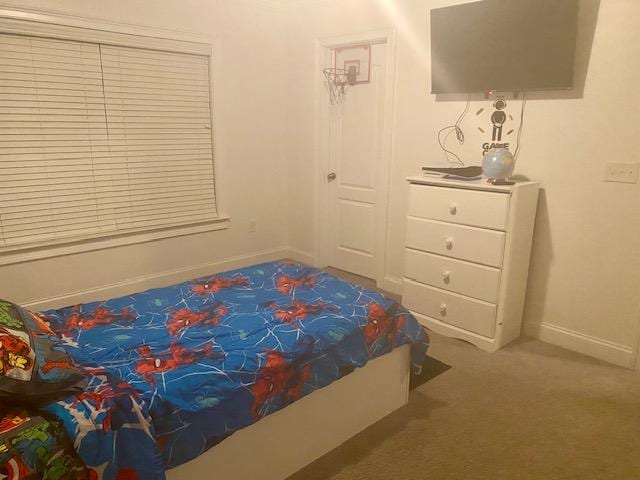 carpeted bedroom featuring baseboards