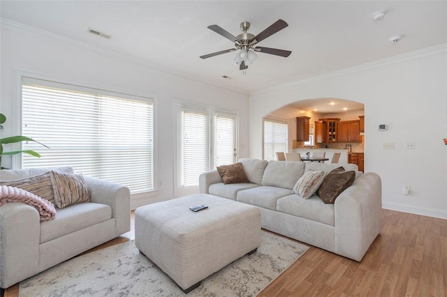 118 Easy Gap Rd, Anderson, SC 29621 - living area featuring arched walkways, light wood-style floors, crown molding, a ceiling fan, and baseboards