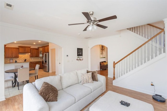 118 Easy Gap Rd, Anderson, SC 29621 - living area with arched walkways, a ceiling fan, stairs, crown molding, and light wood finished floors