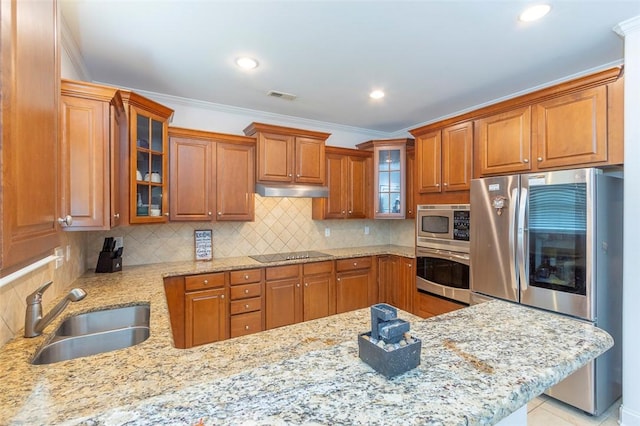 118 Easy Gap Rd, Anderson, SC 29621 - kitchen featuring stainless steel appliances, a sink, brown cabinets, light stone countertops, and tasteful backsplash