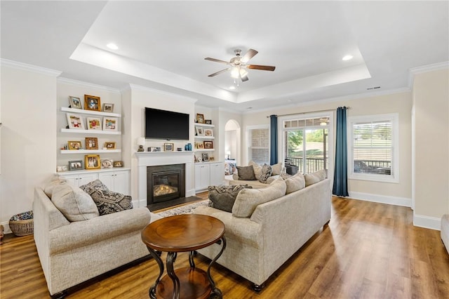 living room with ceiling fan, recessed lighting, wood finished floors, and a raised ceiling