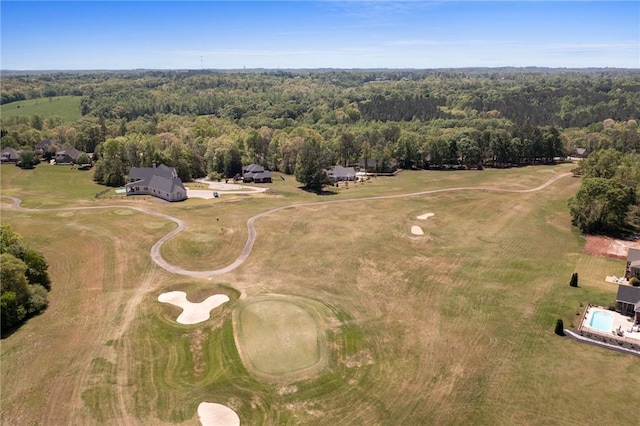 aerial view featuring a wooded view and golf course view