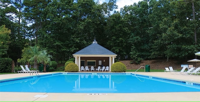 pool with a gazebo and a patio