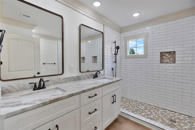 138 Jackson Cir, Anderson, SC 29625 - bathroom featuring wood finished floors, a sink, double vanity, and tiled shower