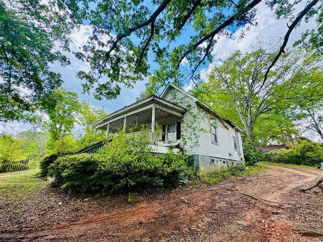 view of home's exterior with dirt driveway