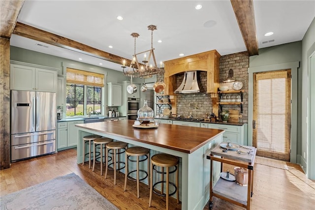 211 Quay Ct, Sunset, SC 29685 - kitchen featuring beamed ceiling, light wood-type flooring, wall chimney exhaust hood, and stainless steel appliances