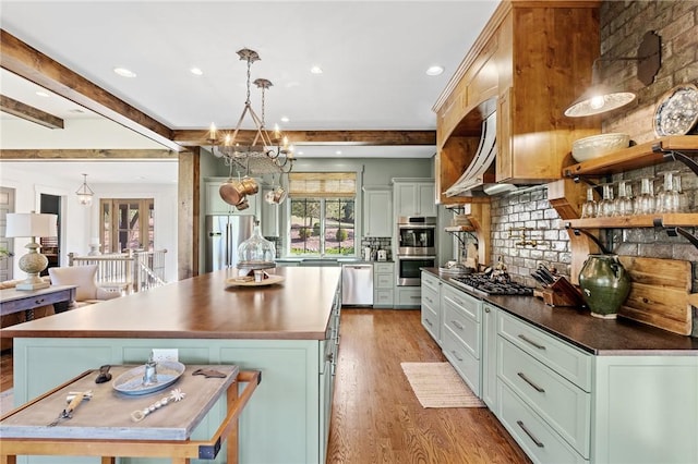 211 Quay Ct, Sunset, SC 29685 - kitchen with light wood finished floors, a center island, tasteful backsplash, dark countertops, and appliances with stainless steel finishes