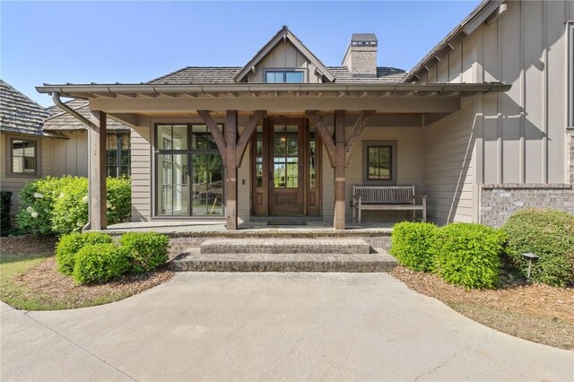211 Quay Ct, Sunset, SC 29685 - doorway to property with a chimney, board and batten siding, and covered porch