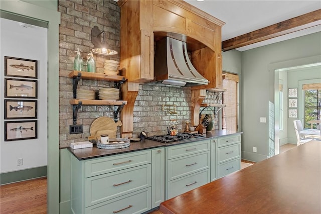 211 Quay Ct, Sunset, SC 29685 - kitchen featuring green cabinetry, backsplash, dark countertops, wall chimney exhaust hood, and beam ceiling