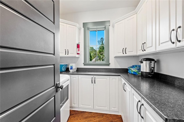 211 Quay Ct, Sunset, SC 29685 - kitchen with white cabinets, dark countertops, and wood finished floors