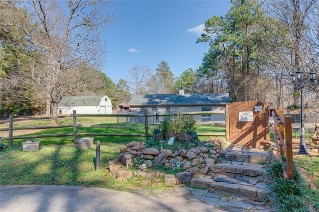 exterior space featuring a lawn and fence