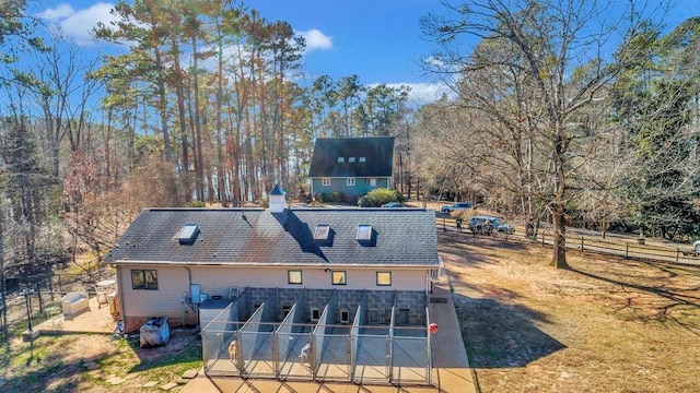 exterior space with a chimney, fence, and a patio area