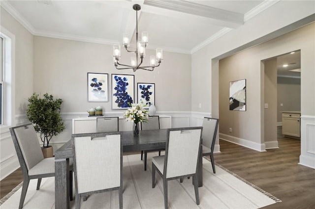 dining area with ornamental molding, a decorative wall, wainscoting, a chandelier, and light wood-style flooring
