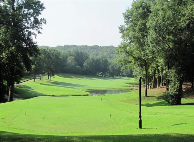 view of home's community featuring a water view and golf course view