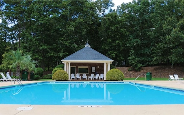 pool with a patio area and a gazebo