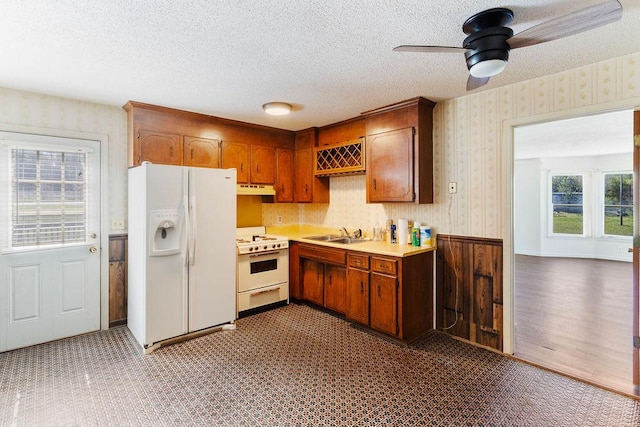 221 Lakeview Dr, Liberty, SC 29657 - kitchen featuring wallpapered walls, under cabinet range hood, and white appliances