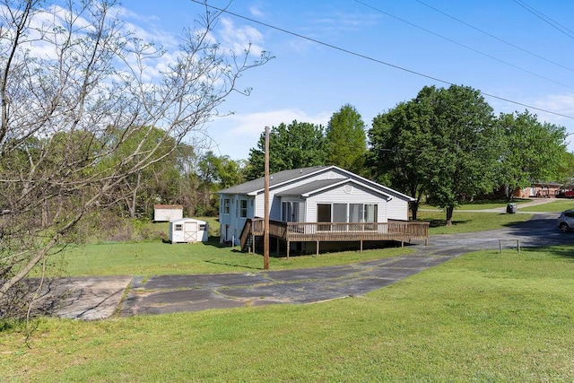221 Lakeview Dr, Liberty, SC 29657 - exterior space with a yard, a wooden deck, driveway, an outbuilding, and a storage unit