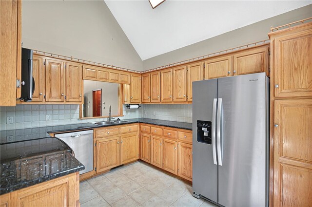 234 Chandlers Ferry Dr, Hartwell, GA 30643 - kitchen with dark stone countertops, a sink, decorative backsplash, light tile patterned floors, and stainless steel appliances