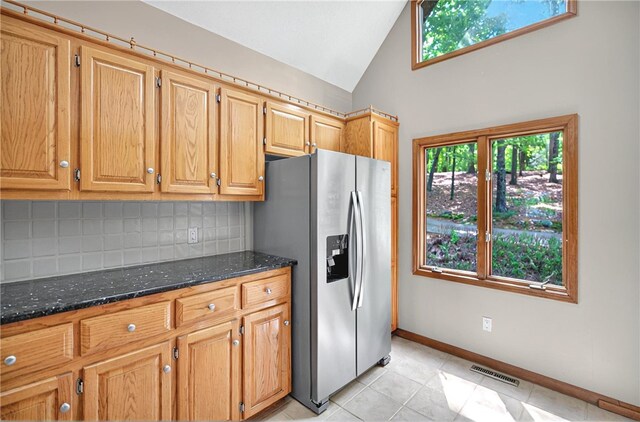 234 Chandlers Ferry Dr, Hartwell, GA 30643 - kitchen featuring stainless steel fridge, dark stone counters, a healthy amount of sunlight, tasteful backsplash, and visible vents