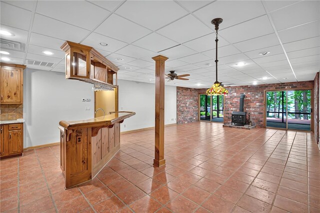 234 Chandlers Ferry Dr, Hartwell, GA 30643 - living room featuring ceiling fan, baseboards, a wood stove, and a drop ceiling