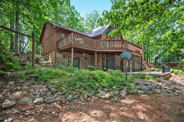 234 Chandlers Ferry Dr, Hartwell, GA 30643 - rear view of property with stone siding, a sunroom, and a deck