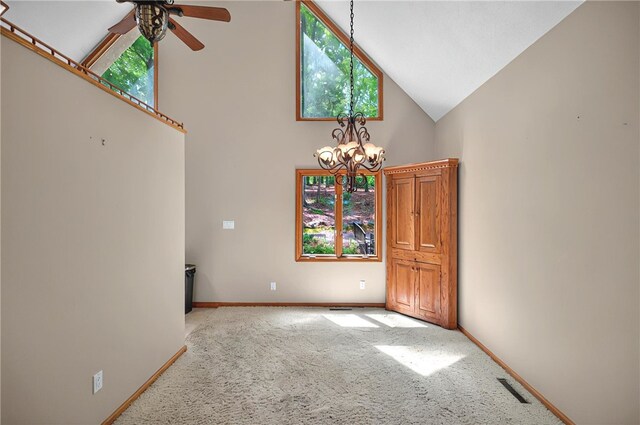 234 Chandlers Ferry Dr, Hartwell, GA 30643 - empty room featuring carpet, visible vents, baseboards, high vaulted ceiling, and ceiling fan with notable chandelier