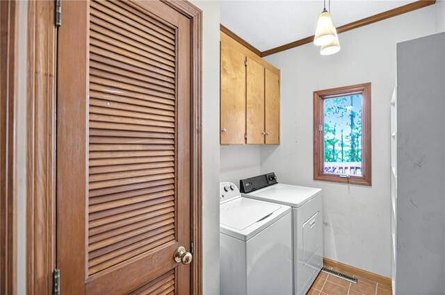 234 Chandlers Ferry Dr, Hartwell, GA 30643 - clothes washing area with light tile patterned flooring, washer and dryer, cabinet space, baseboards, and ornamental molding