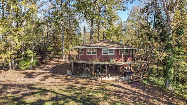 back of house with a wooden deck, a patio area, and stairway