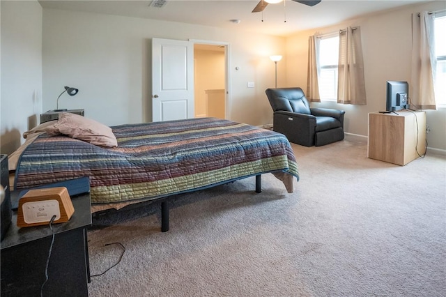 carpeted bedroom with ceiling fan, baseboards, and visible vents