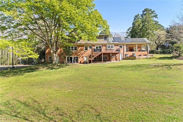 112 Briar Creek Ln, Anderson, SC 29621 - rear view of house featuring a wooden deck, roof mounted solar panels, a lawn, and stairs