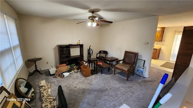 interior space with ceiling fan